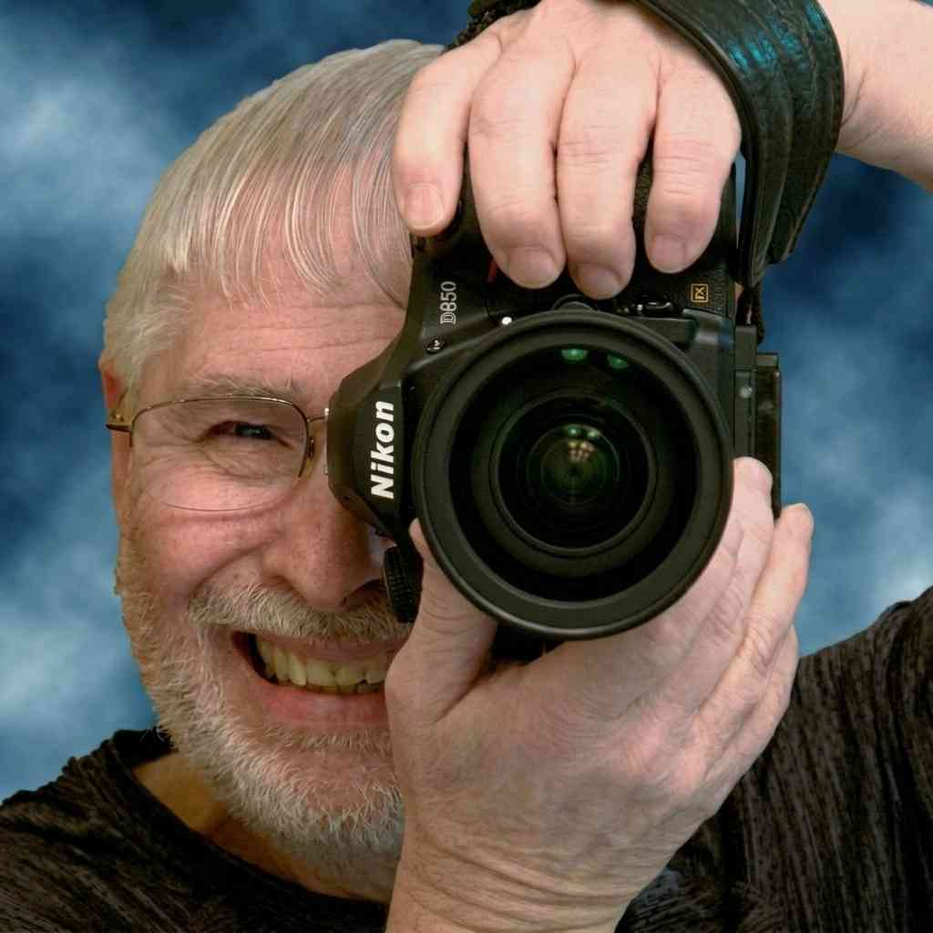 Portrait of photographer Mike Skultety with his Canon DSLR