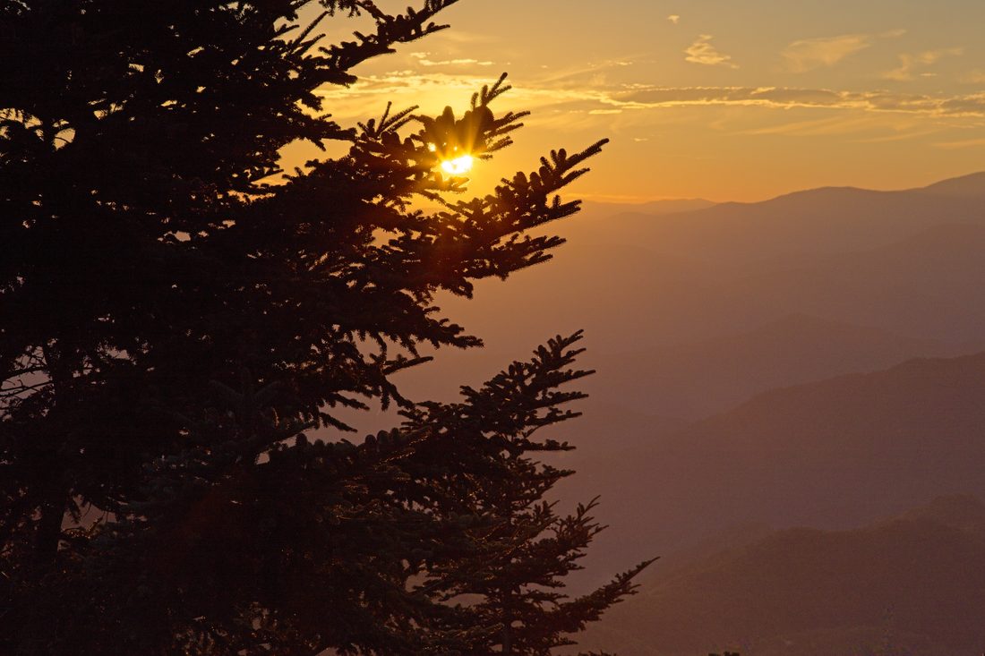 Soft sunset light spreading across distant Blue Ridge ridgelines